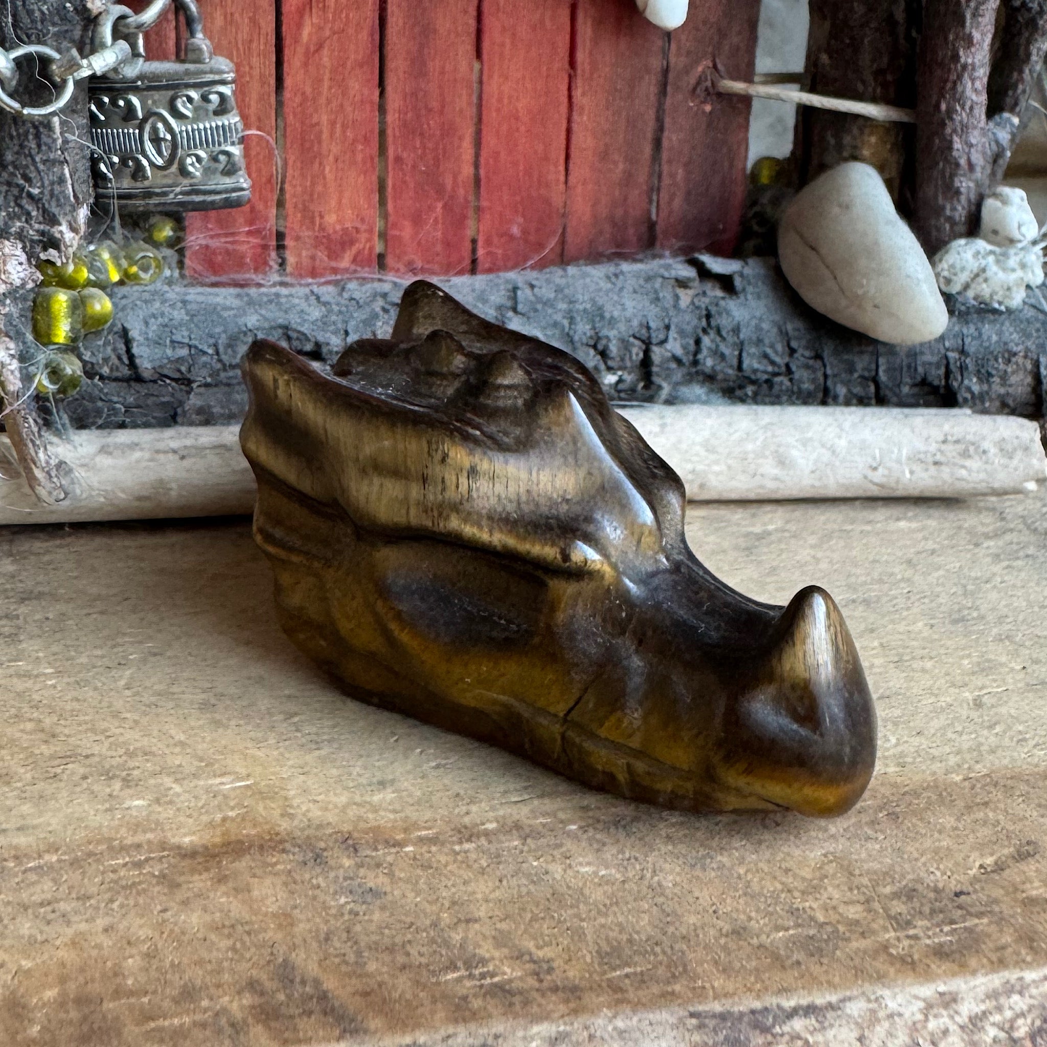 profiel foto van een klein drakenschedel van edelsteen tijgeroog